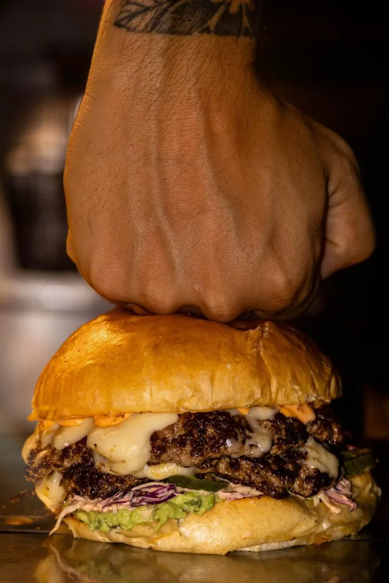 Chop House burger held in hand, close up